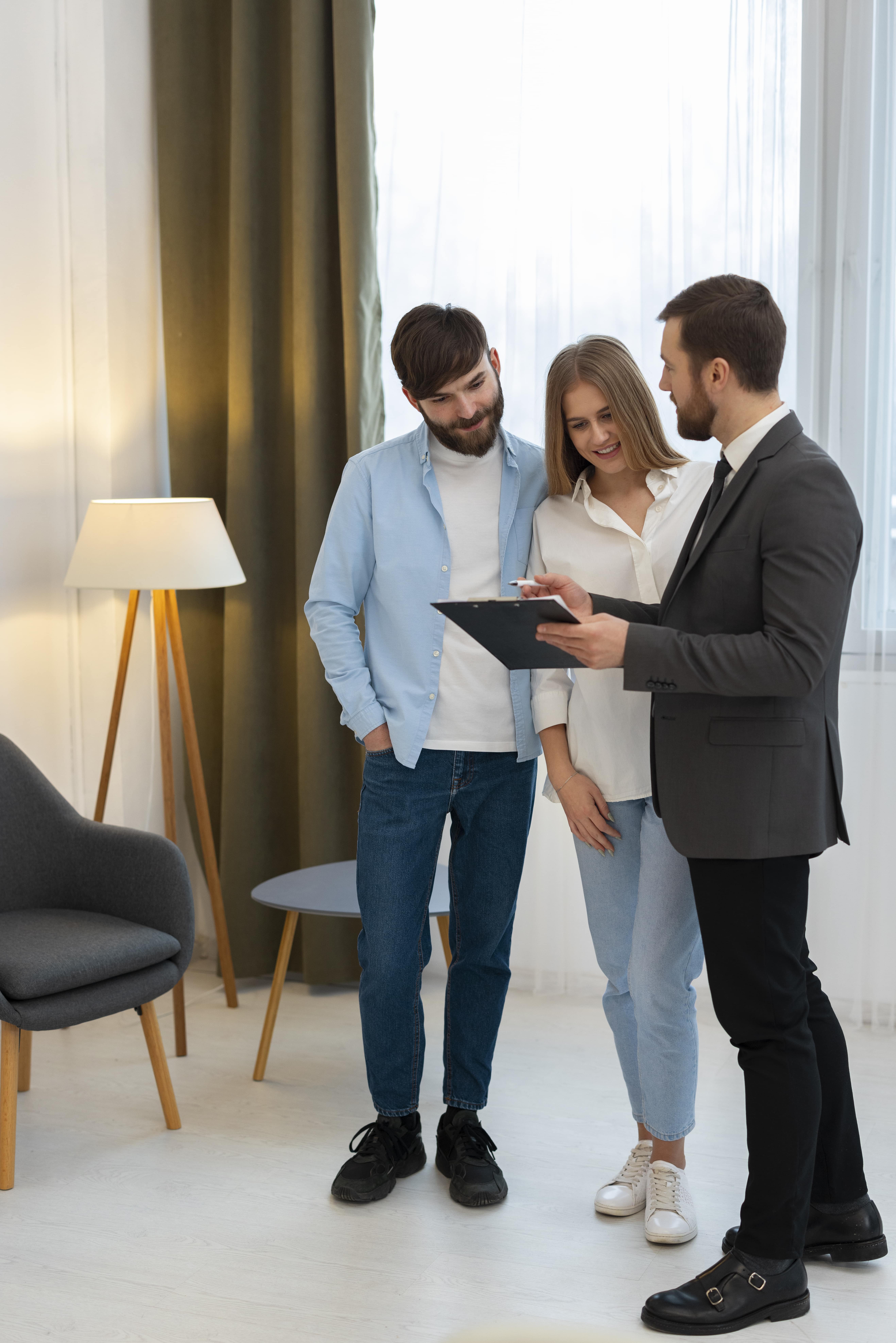 male-real-estate-agent-doing-business-showing-house-potential-buying-couple RECAMP | Insurance Agent Coaching Training